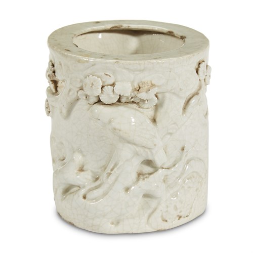 Lot 100 - A white-glazed molded, incised and applied porcelain  "Hawk and Pine" brush pot