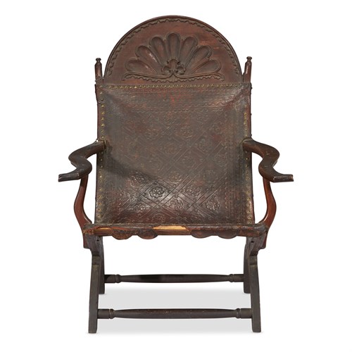 Lot 22 - Carved mahogany and embossed leather campeche chair