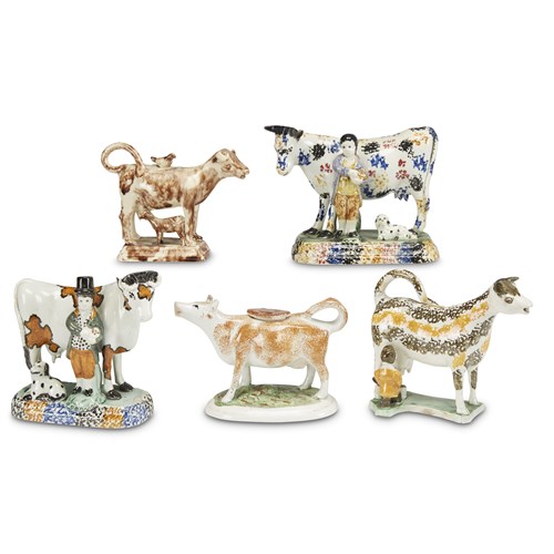 Lot 29 - Assembled group of five pearlware and Prattware cow figures and creamers
