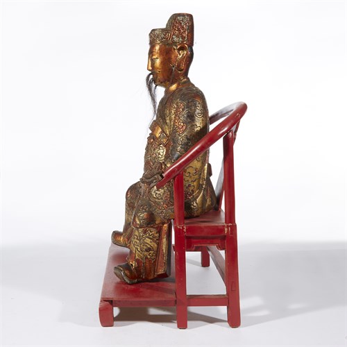 Lot 179 - A Chinese gilt lacquered wood figure of a dignitary on later horseshoe-back seat