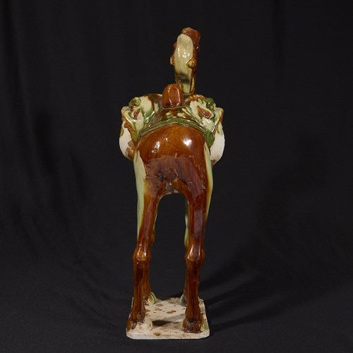 Lot 23 - A Chinese sancai-glazed pottery model of a camel