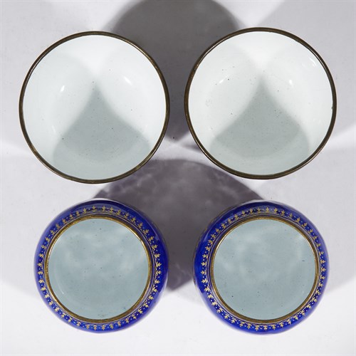 Lot 189 - A pair of Chinese enameled metal tea bowls and warming stands
