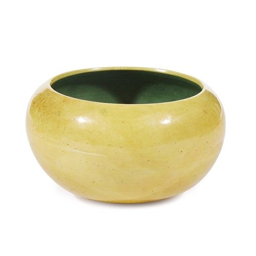 Lot 140 - A Chinese yellow and green-enameled "alms bowl" with associated wood stand