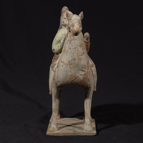 Lot 18 - A Chinese painted grey pottery horse and rider