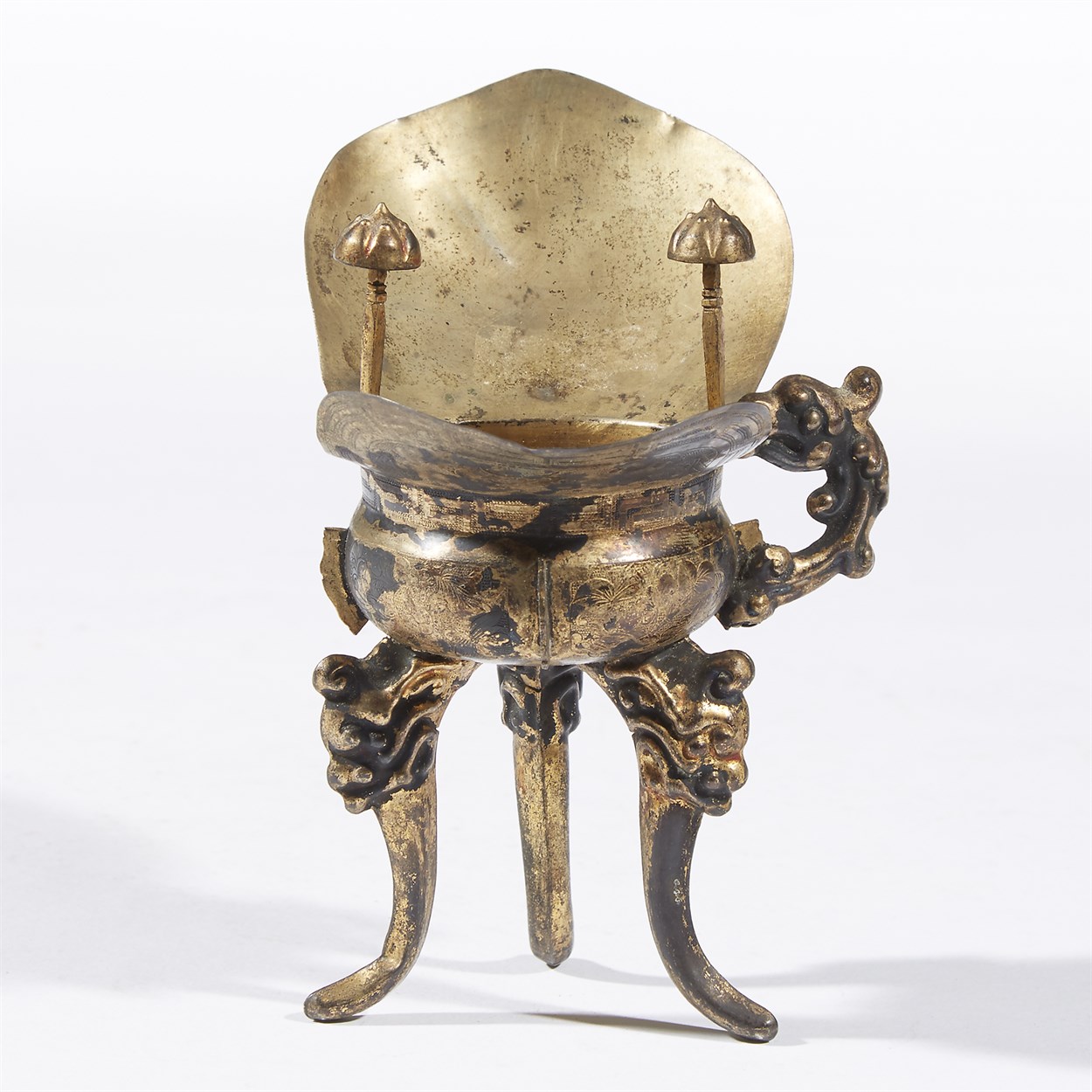 Lot 187 - A Chinese silver-gilt tripod libation cup, jue