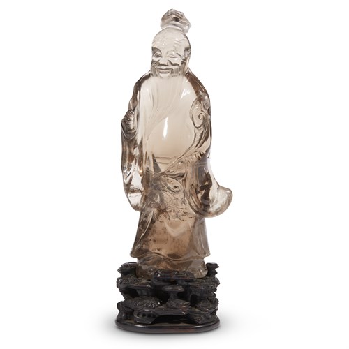 Lot 265 - A Chinese carved smokey quartz figure of an immortal on carved hardwood stand