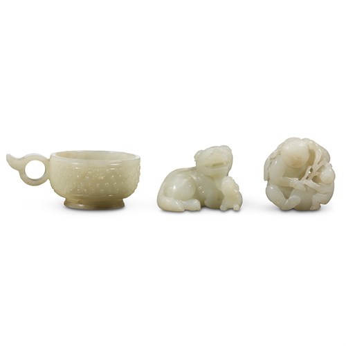 Lot 258 - Three Chinese carved white and pale celadon jades: "Tashi Xiaoshi", a libation cup, and two boys with lingzhi