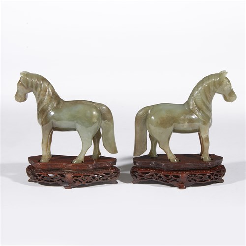 Lot 267 - A pair of Chinese carved celadon-grey jade horses