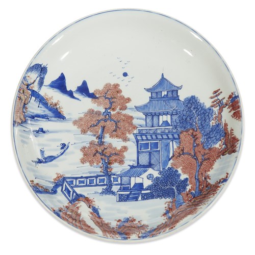 Lot 107 - A Chinese underglaze blue and red-decorated porcelain "River Landscape with Pavilion" charger