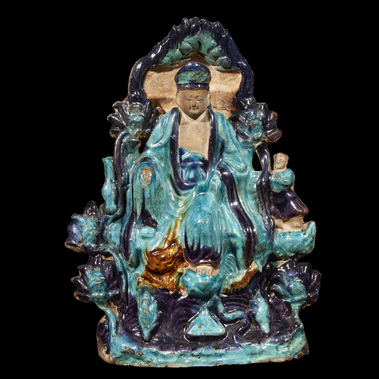Lot 72 - A Chinese sancai-glazed tileworks seated "Water-Moon" Guanyin with attendant
