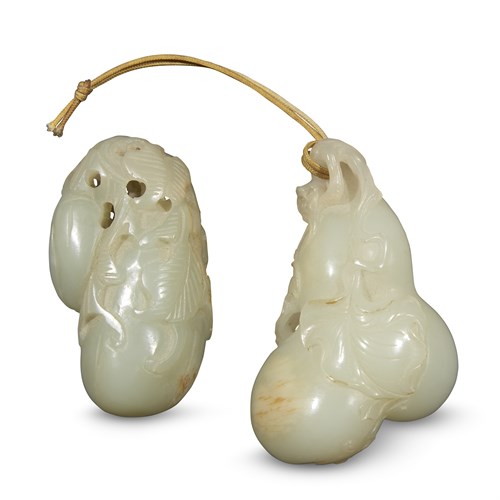Lot 262 - A Chinese carved white jade "Gourds" toggle, and a celadon jade "Melons" toggle
