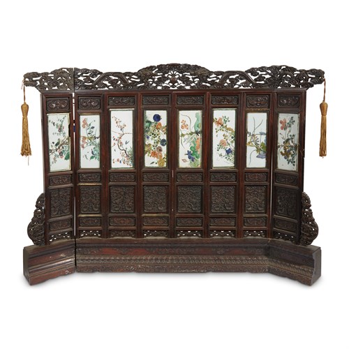 Lot 108 - A Chinese eight panel porcelain and carved hardwood table screen