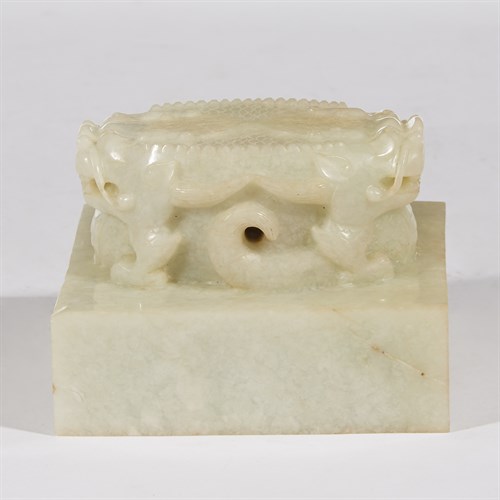 Lot 271 - A Chinese pale celadon jade "Double-Dragon" seal