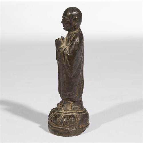 Lot 73 - A Chinese bronze figure of a Buddhist attendant