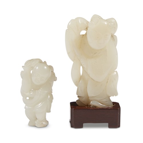 Lot 254 - Two Chinese carved white jade "Boys" toggles