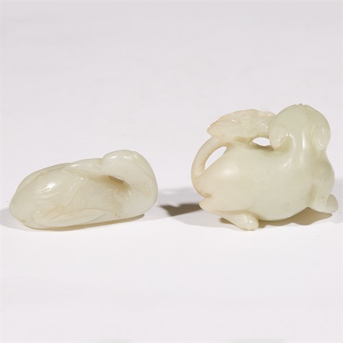 Lot 253 - A Chinese carved jade figure of a "Crane and Peach" and a "Cat and Butterfly" toggle