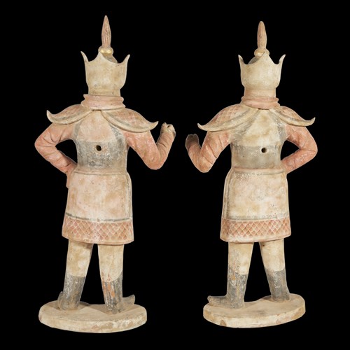 Lot 24 - A pair of Chinese painted and parcel gilt pottery figures of warriors