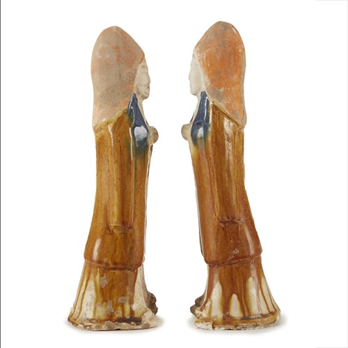 Lot 30 - A pair of Chinese painted and sancai-glazed attendants