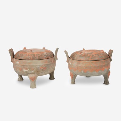 Lot 11 - A pair of Chinese painted grey pottery covered tripod vessels, Ding