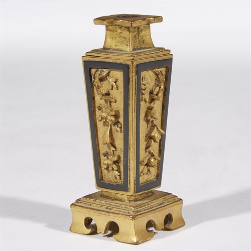 Lot 185 - A Chinese gilt and patinated copper alloy miniature incense tool vase
