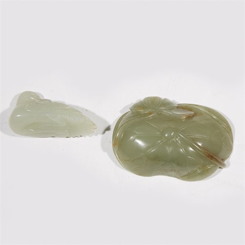 Lot 250 - A small Chinese pale celadon jade "Crane" toggle and a small celadon jade lotus leaf dish