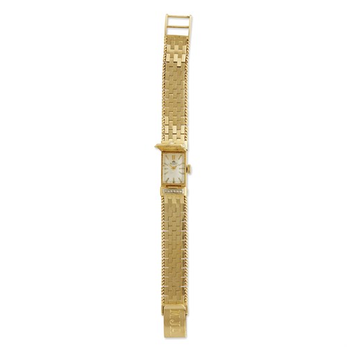 Lot 64 - An eighteen karat gold and diamond covered dial bracelet watch, Bucherer
