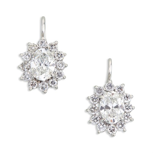 Lot 134 - A pair of diamond and fourteen karat white gold drop earrings