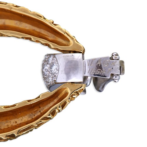 Lot 152 - A pair of diamond and two-tone eighteen karat gold earrings, Van Cleef & Arpels