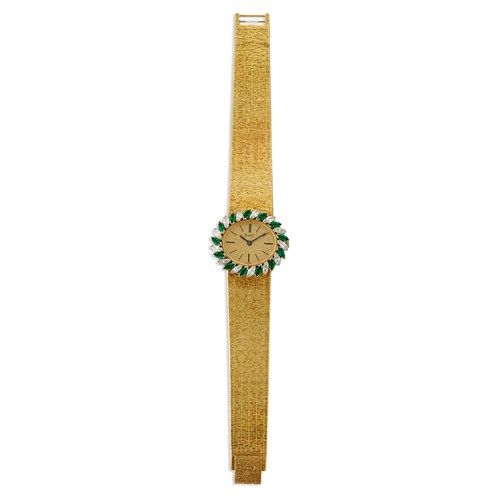 Lot 149 - An eighteen karat gold, diamond, and emerald bracelet wristwatch, Piaget