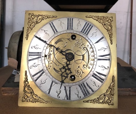 Lot 58 - An engraved brass clock face and movement