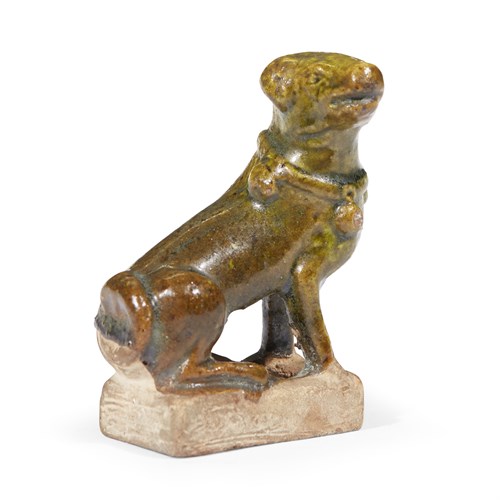 Lot 14 - A Chinese green-glazed pottery figure of a seated hound