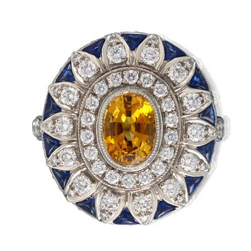 Lot 152 - A yellow sapphire, blue sapphire, and diamond ring