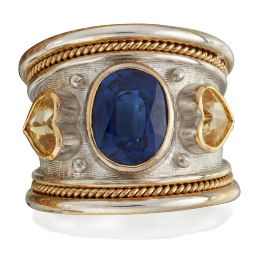Lot 101 - A yellow and blue sapphire and two-tone eighteen karat gold ring, Elizabeth Gage