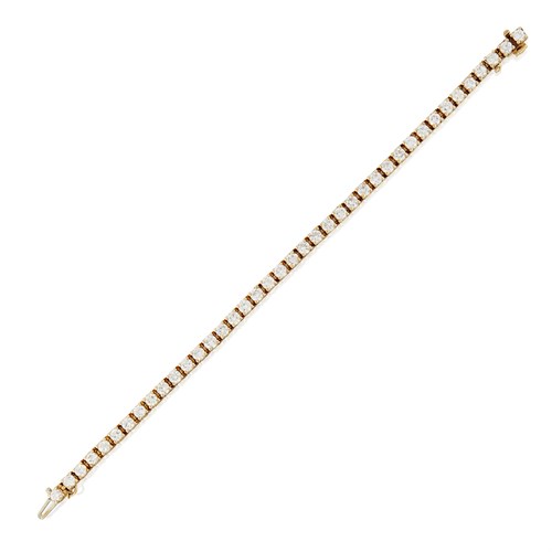 Lot 13 - A fourteen karat gold and diamond line bracelet