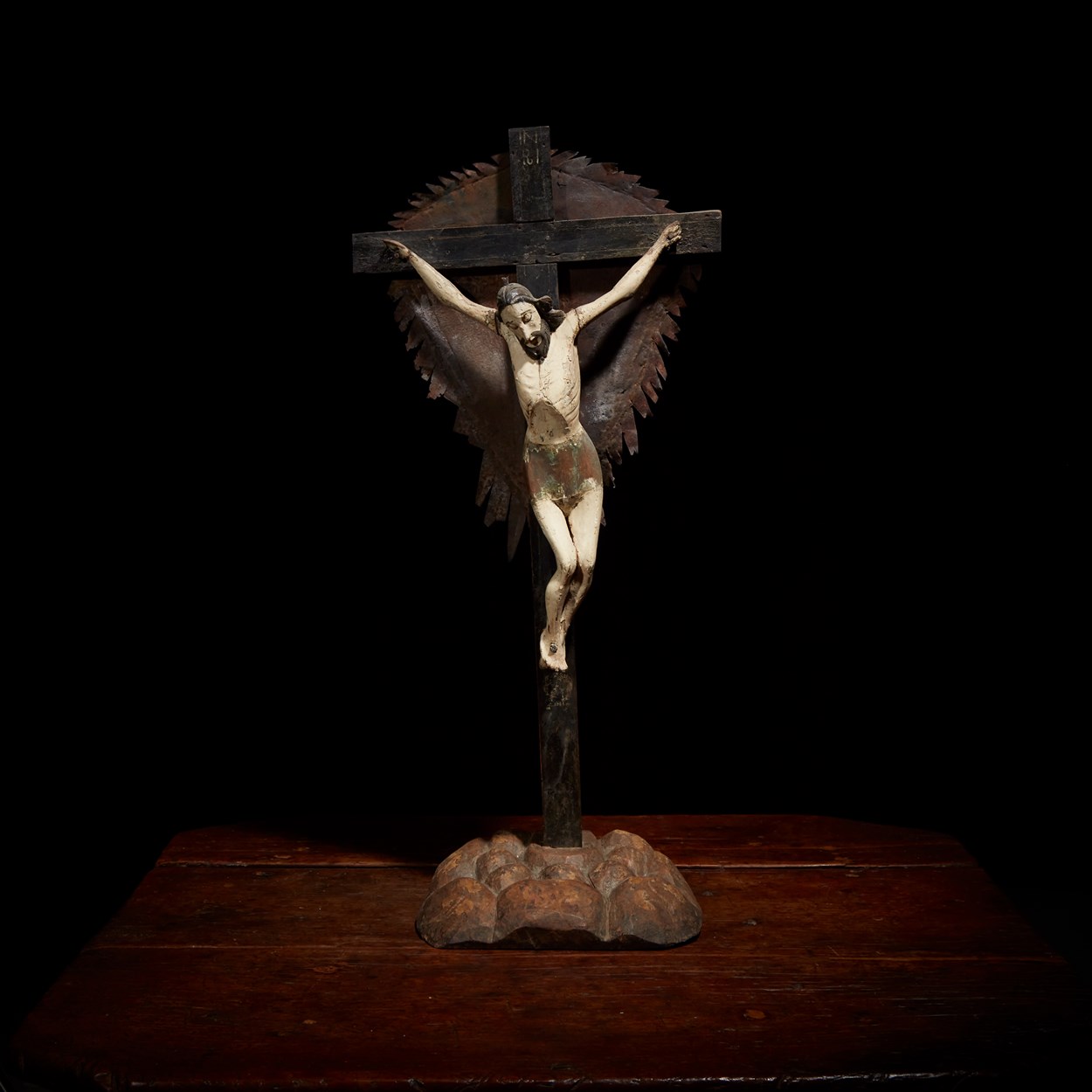 Lot 25 - A Spanish Colonial carved and polychromed wood and pressed metal crucifix