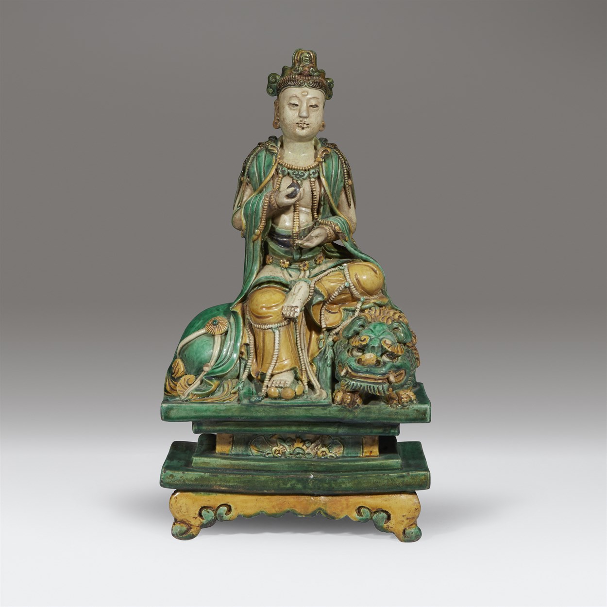 Lot 82 - A Chinese sancai-glazed figure of a seated Bodhisattva