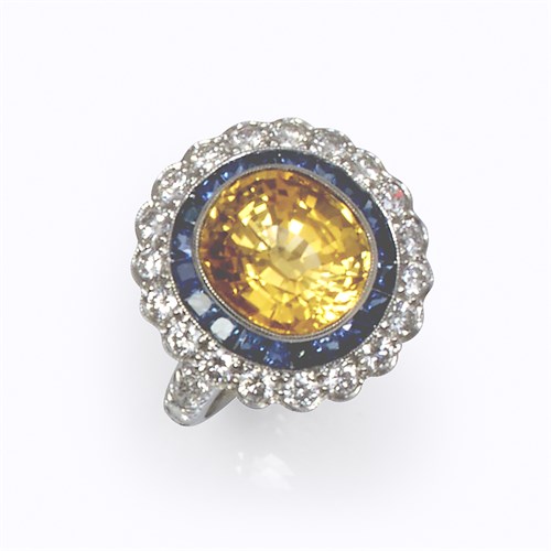 Lot 92 - A yellow sapphire, sapphire, diamond, and platinum ring