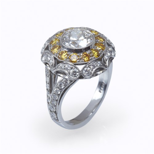 Lot 66 - A diamond, colored diamond, and platinum ring