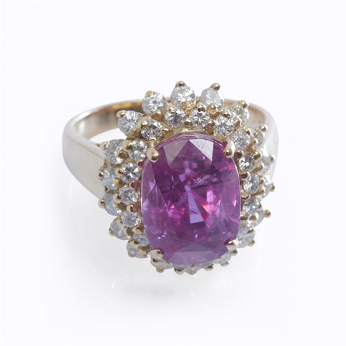 Lot 38 - A pink sapphire, diamond, and fourteen karat gold ring
