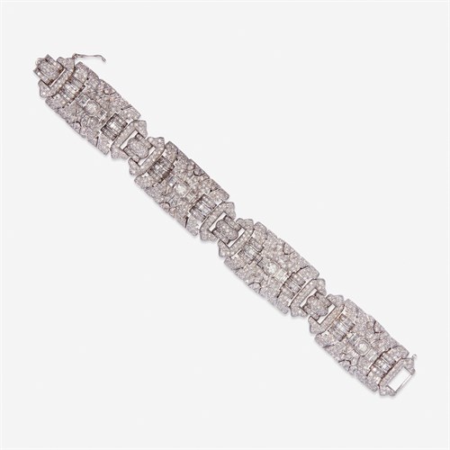 Lot 63 - A diamond and eighteen karat white gold strap bracelet