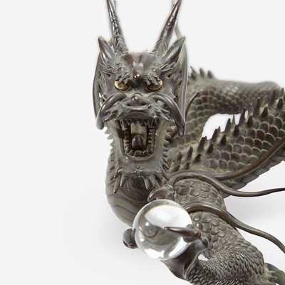 Lot 127 - A Japanese patinated bronze dragon and rock crystal sphere