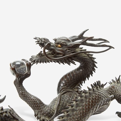 Lot 127 - A Japanese patinated bronze dragon and rock crystal sphere