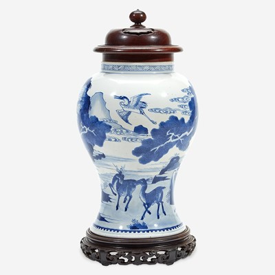 Lot 6 - A Chinese blue and white porcelain vase with carved wood cover and stand