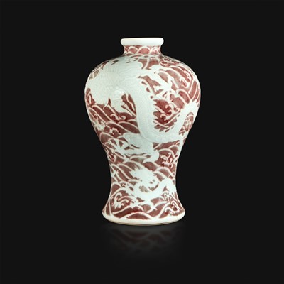 Lot 12 - A Chinese carved and underglaze red "Dragons and Waves" vase, Meiping