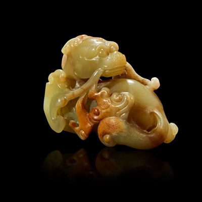 Lot 87 - A Chinese small celadon, beige and russet jade figure of a mythical beast