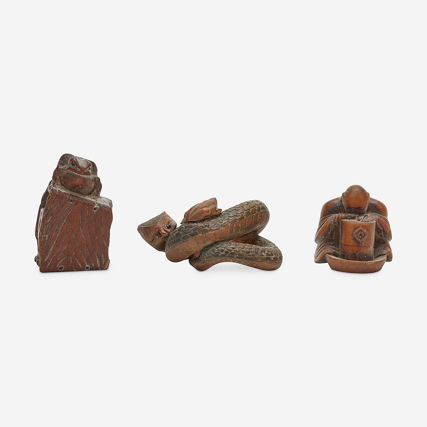 Lot 138 - Three Japanese carved wood netsuke: measure and toad, snake and toad, monk and jar