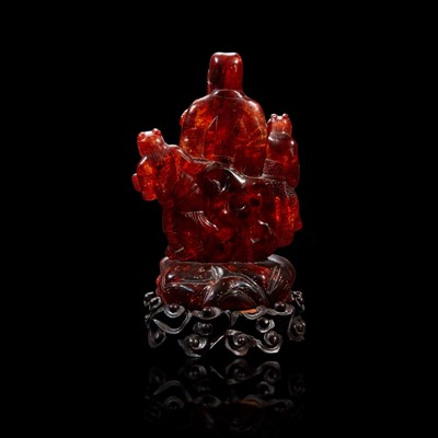 Lot 97 - A Chinese carved amber figure of a sage and acolytes