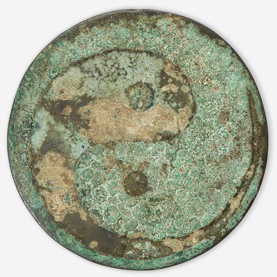 Lot 108 - A Chinese bronze "Twin Carp" circular mirror