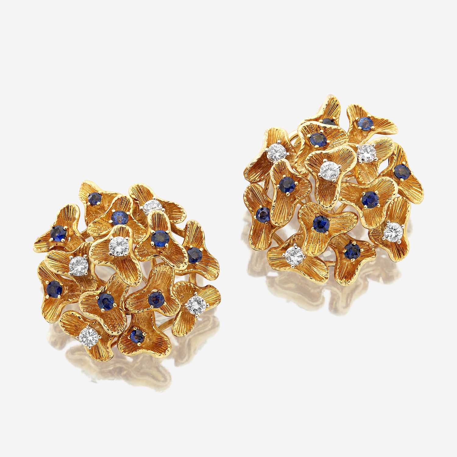Lot 36 - A pair of eighteen karat gold, sapphire, and diamond ear clips