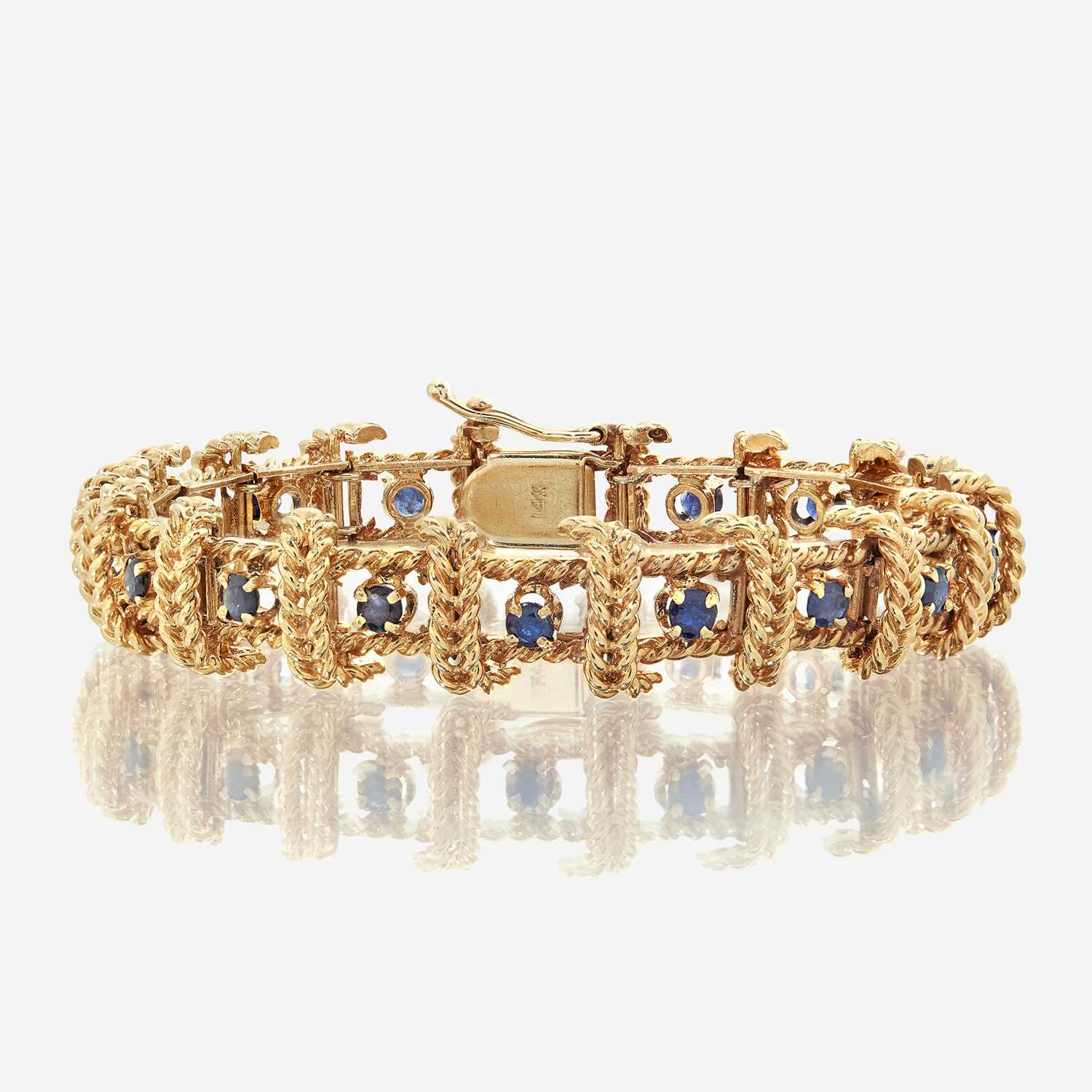 Lot 38 - A fourteen karat gold and sapphire bracelet